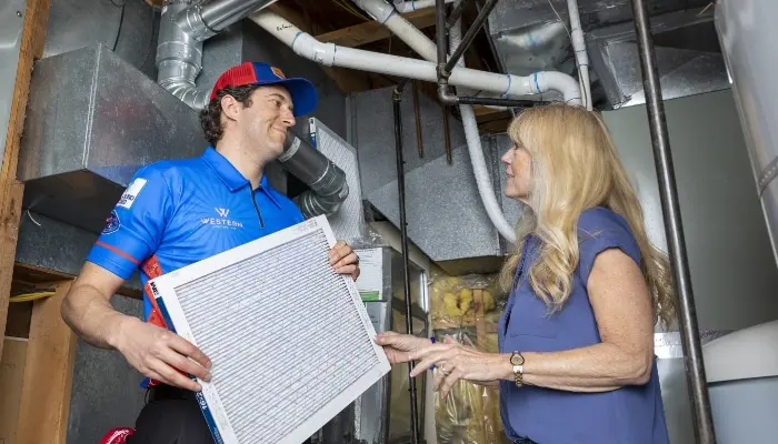 Western Technician Holding Filter With Customer