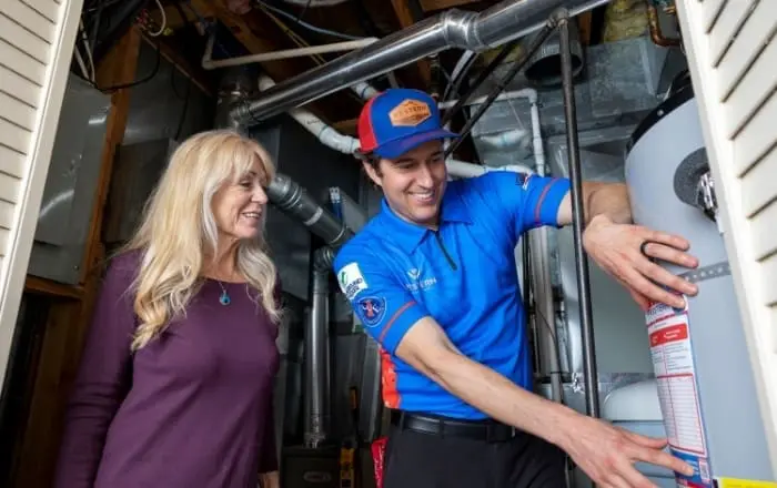 Commercial HVAC Services Sandy UT - Western Heating, Air & Plumbing HVAC technician explaining equipment inspection to a customer during commercial HVAC service in Sandy, UT.
