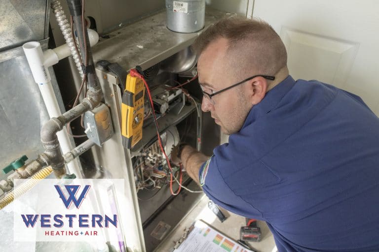 Western tech performing a service on an HVAC unit