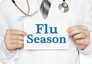 Doctor holding a card with Flu Season, medical concept