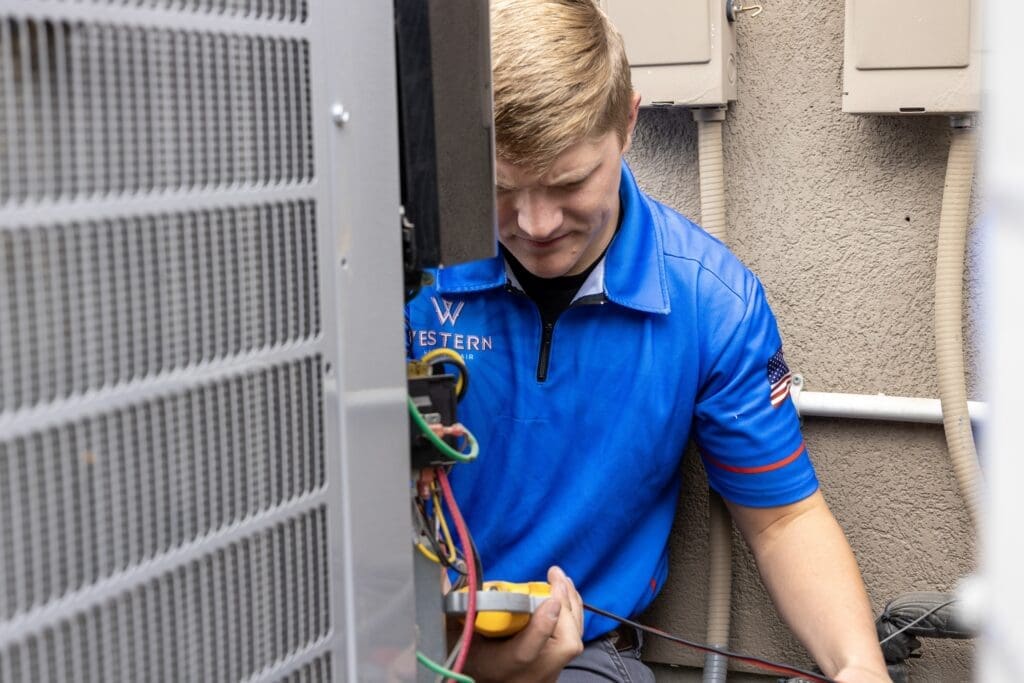 HVAC technician performing seasonal AC tune-up in Sandy UT