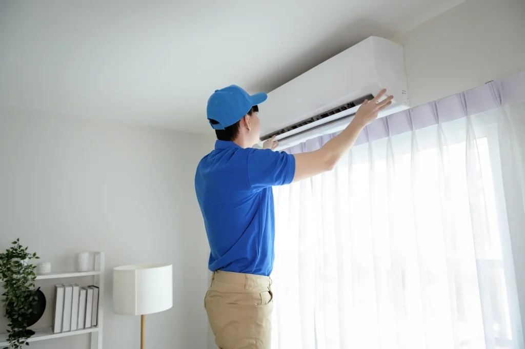 technician-service-man-checking-air-conditioner